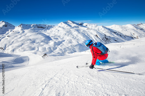 Young attractive skier skiing in famous ski resort in Alps, Livigno, Italy, Europe