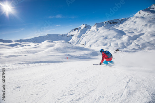 Young attractive skier skiing in famous ski resort in Alps, Livigno, Italy, Europe