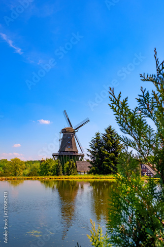 Colorful windmill in Gifhorn of the lake in summer