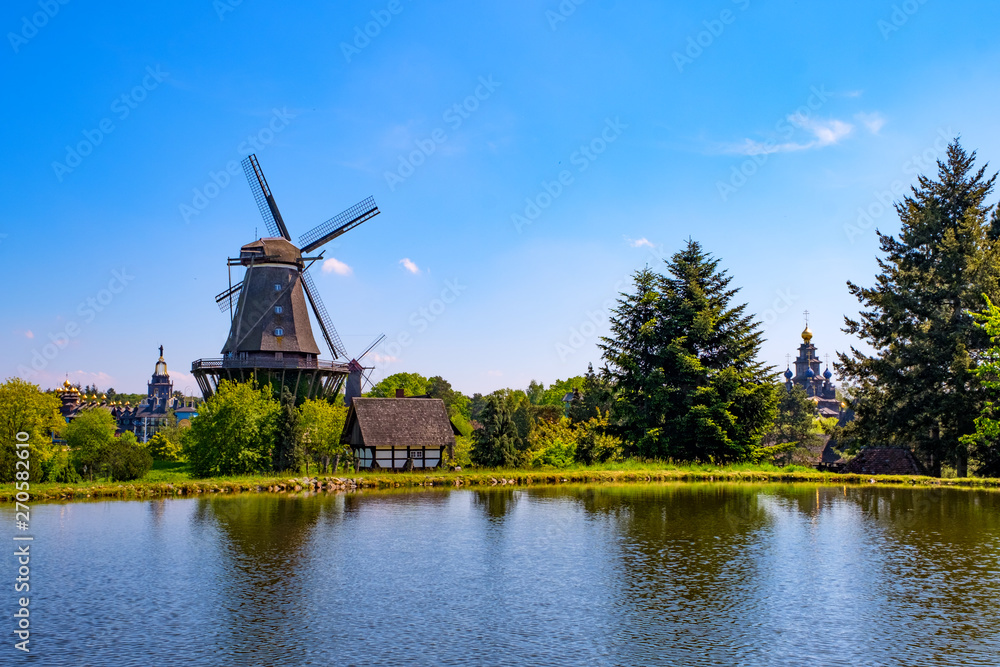 Colorful windmill in Gifhorn of the lake in summer