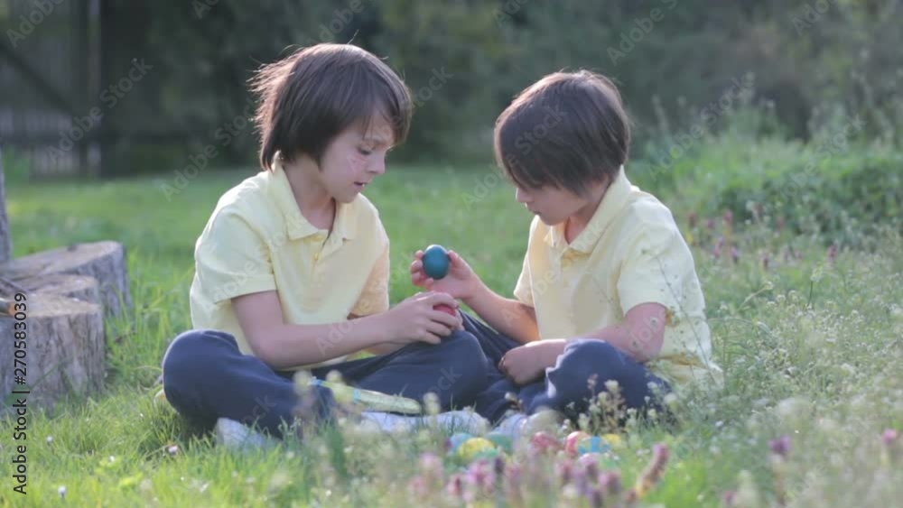 Sweet children, boy brothers with bunny ears, egg hunting for Easter, child and Easter day traditions. Kids and holidays Sweet children, boy brothers with bunny ears, egg hunting for Easter, child and Easter day traditions. Kids and holidays