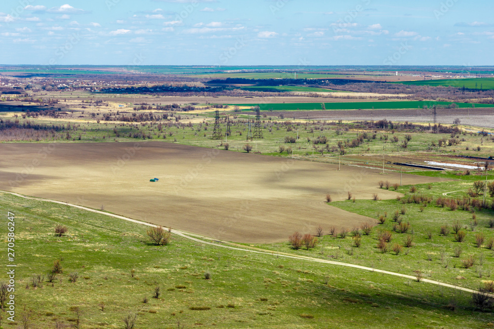 The top view of the agricultural field among grassland at the springtime. Rostov-in-Don region, Russia