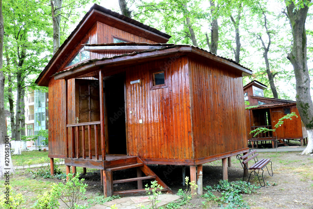 Wooden bungalows among oaks trees. Wooden log house. Azerbaijan, Lankaran Wooden bungalows among oaks trees. Wooden log house. Azerbaijan, Lankaran