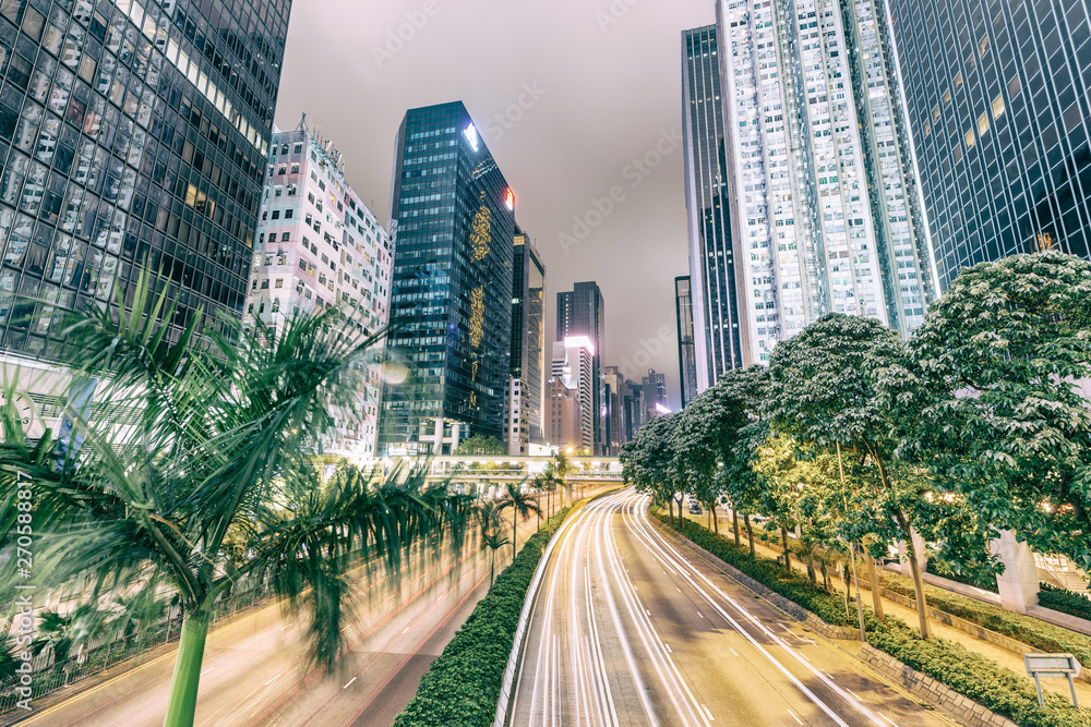 HONG KONG - MAY 4, 2014: City streets and traffic at night. Hong Kong hosts 15 million tourists annually