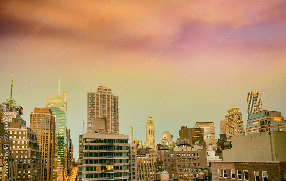 Sunset aerial view of Midtown Manhattan skyline from a New York City rooftop