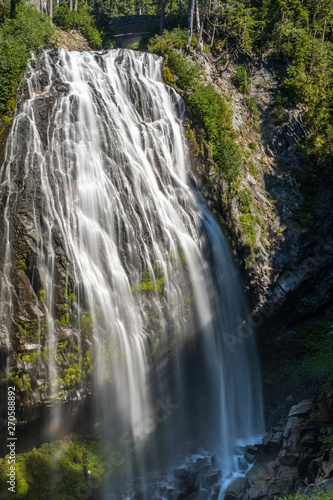 A large drop waterfall photographed on a long exposure to create blurred motion to the water, the Narada Waterfall, Mount Rainier National Park, Washington State, USA. nobody in the image