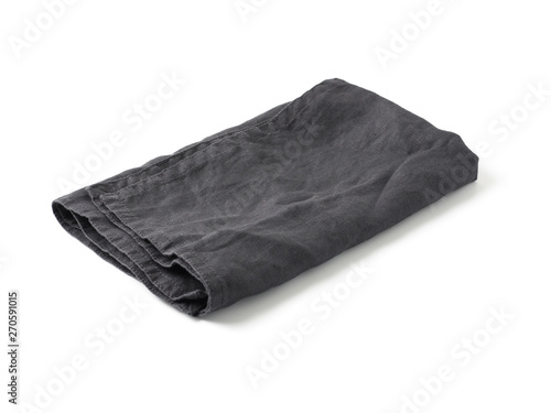 Side view on folded dark black linen napkin isolated on white background. Anthracite grey linen napkin. Isolated on white with clipping path.