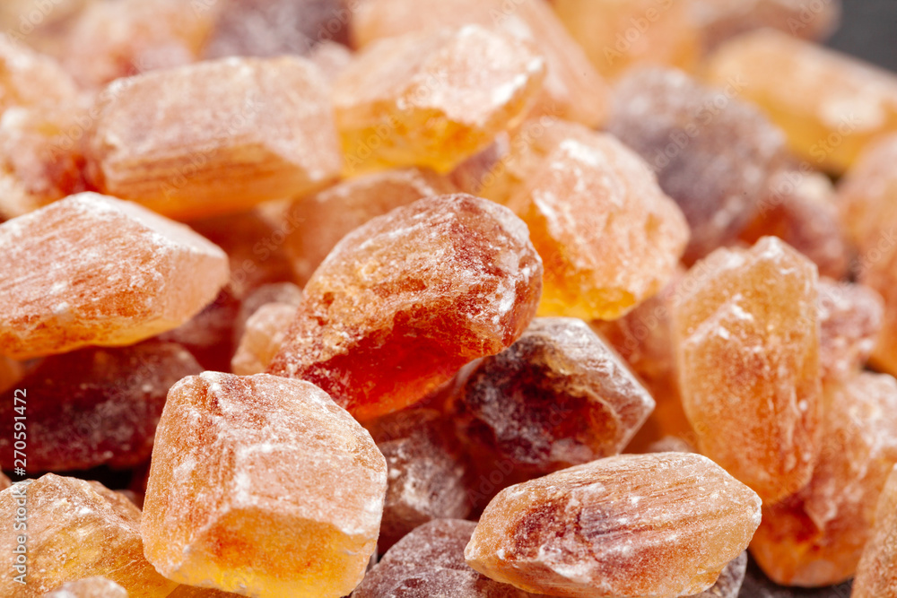 brown sugar rock organic crystalline close up on dark background brown sugar rock organic crystalline close up on dark background