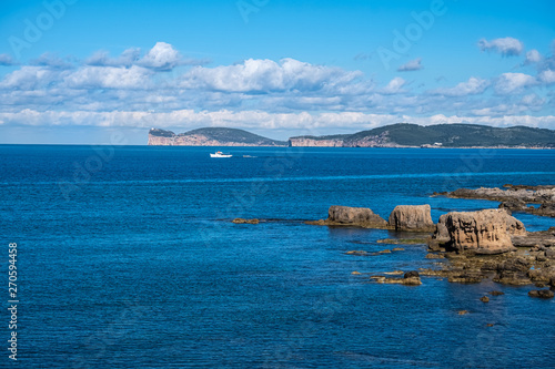 View of Capo Caccia from Alghero (L'Alguer), province of Sassari , Sardinia, Italy. Famous for the beauty of its coast and beaches and its historical city center
