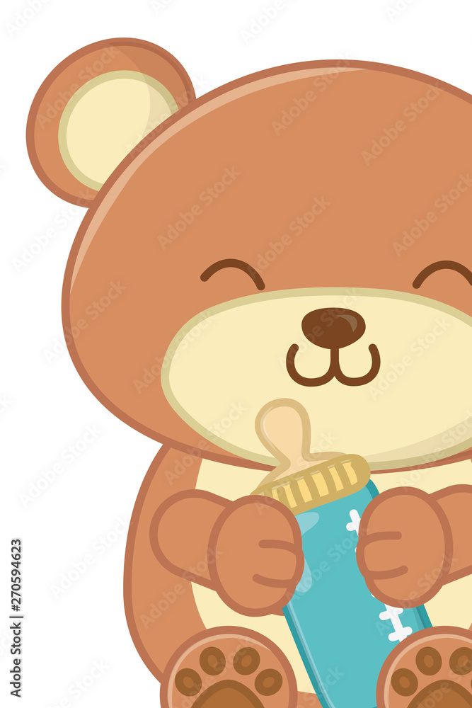 Fototapeta premium toy bear holding a feeding bottle close up