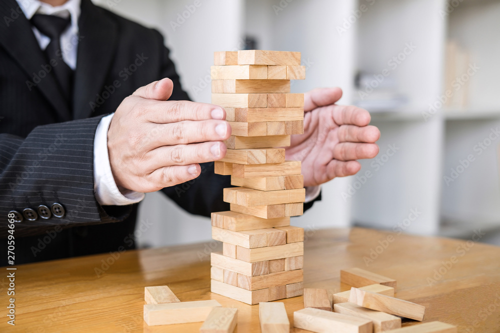 Alternative risk concept, plan and strategy in business protect with balance wooden stack with hand control risk shape Alternative risk concept, plan and strategy in business protect with balance wooden stack with hand control risk shape