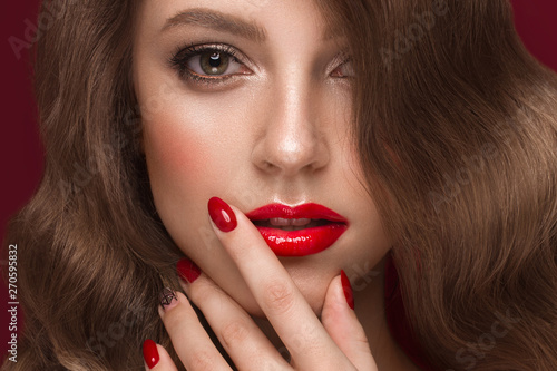 Beautiful girl with a classic make up, curls hair and multi-colored nails. Manicure design. Beauty face.