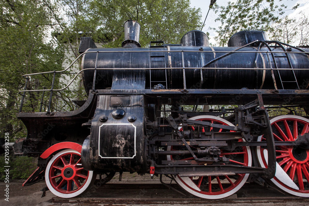 Old  black train with big red wheels . Retro train.