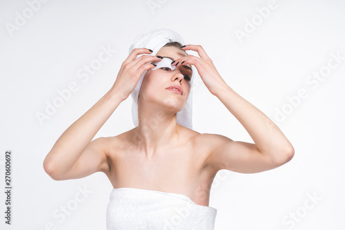 young girl sticks patch for eyes. Nude in a towel on the chest and head. European 20 years old