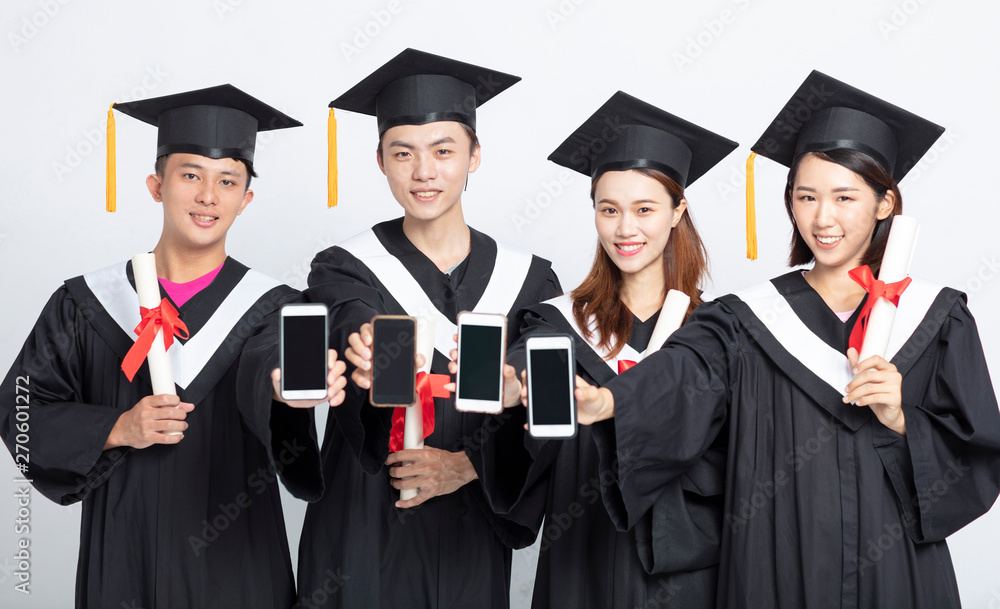 Group of graduate students showing smart phone Group of graduate students showing smart phone