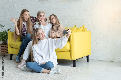 Happy attractive lesbian family in casual clothes making selfie