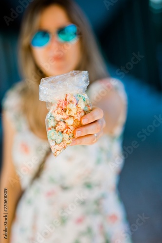 A woman offering sweet popcorn.
