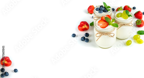 Fototapeta Naklejka Na Ścianę i Meble -  Fresh yogurt with berries in glass jars. Dairy products. Healthy food, dieting and breakfast concept. Long format for banner, copy space