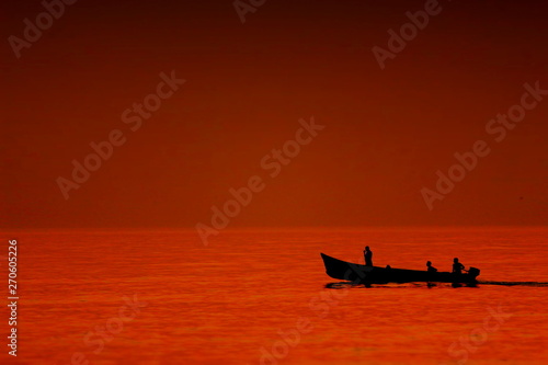 Fishermen on a boat Silhouette during Sunset