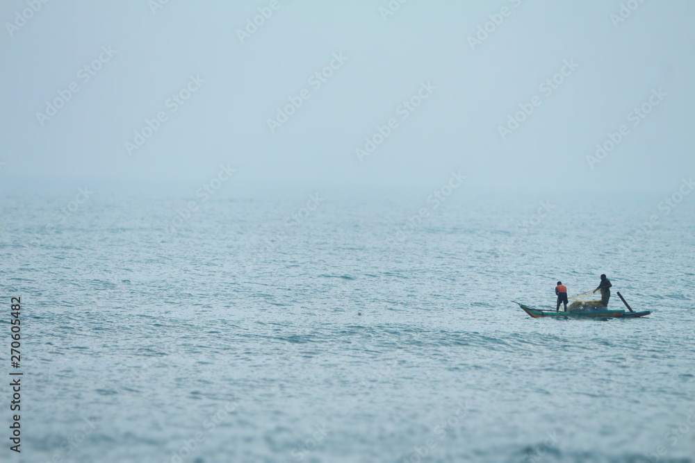 Naklejka premium Boat Sailing in the Ocean