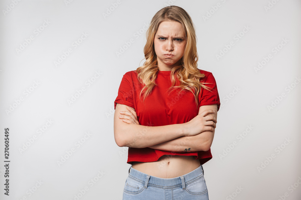 Displeased young pretty beautiful woman posing isolated over white wall background.