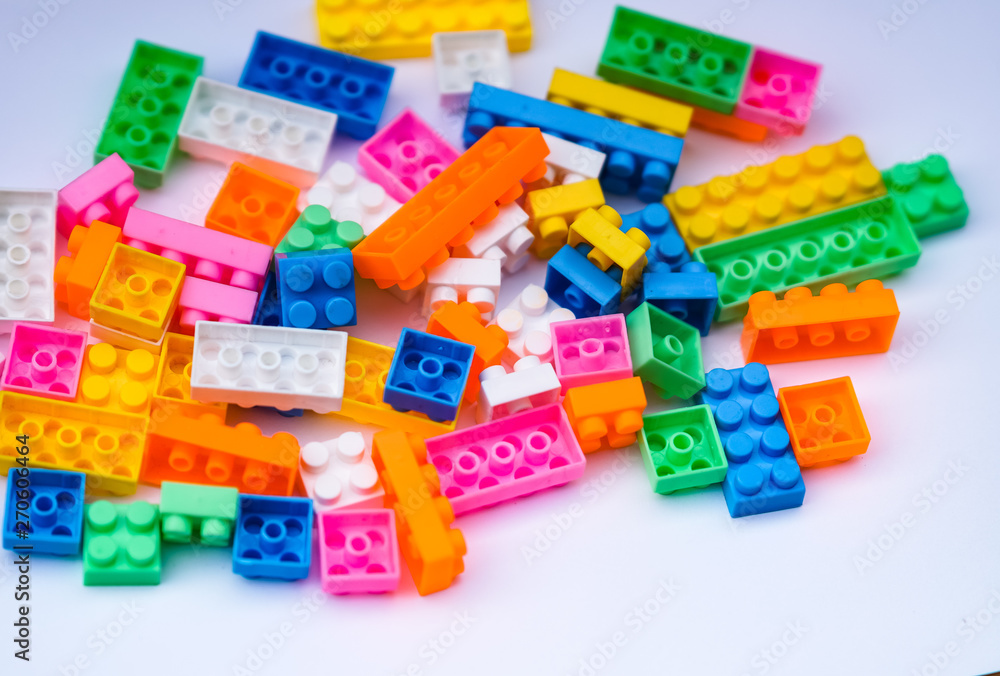 Multicoloured plastic construction blocks or bricks toy on white background Multicoloured plastic construction blocks or bricks toy on white background