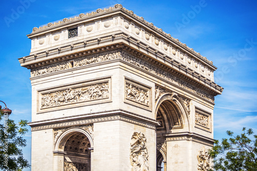 Landscape of the beautiful and monumental Arc de Triomphe on the Place of the General De Gaulle in Paris during a beautiful sunny summer day - Paris, France
