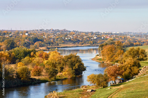 View of the village on the banks of the river in early autumn. Autumn rural landscape