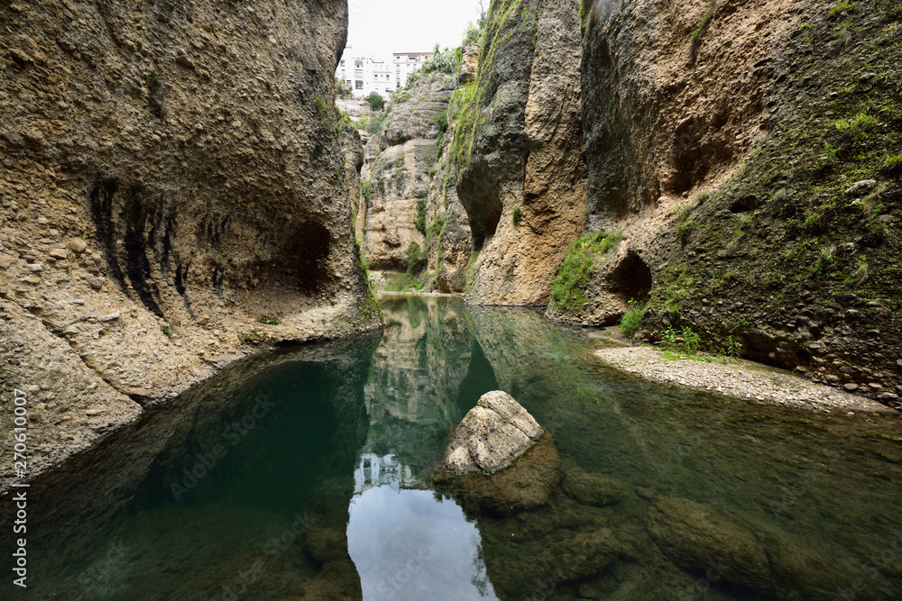 Steep cliffs at Guadalevin river at El Tajo Gorge from the bottom of the secret water mine in Ronda Spain Steep cliffs at Guadalevin river at El Tajo Gorge from the bottom of the secret water mine in Ronda Spain