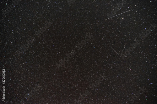 dark night sky with many stars and meteors background image