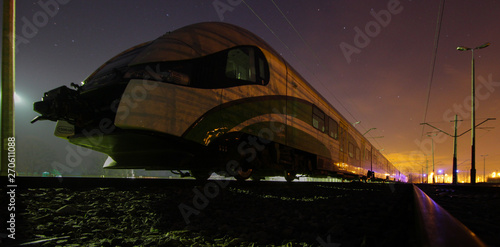 A suburban train standing at night on a siding. © UNIT80