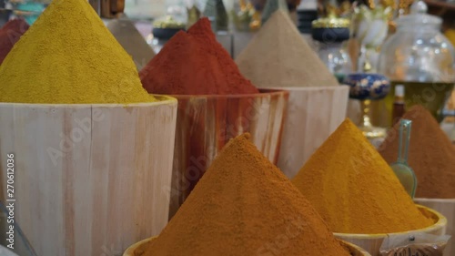 Selection of different arabian spices on a traditional Moroccan market souk in Marrakech, Morocco. A lot of pepper, cardamon, cumin, curry