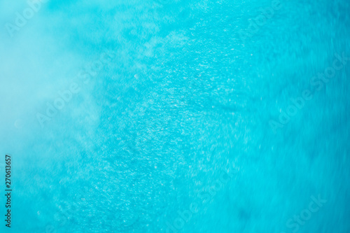 Abstract light blue paint background. Acrylic clear water like pattern texture. Defocused turquoise color uneven surface.