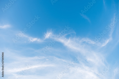 Fluffy cloud is floating on the clear blue sky.