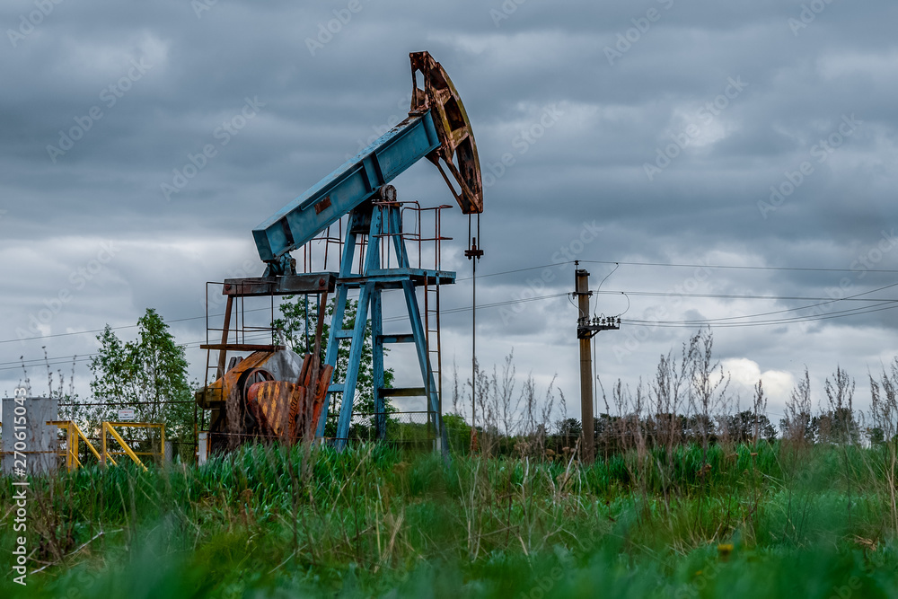 Oil and gas industry. Silhouette oil pumps on a sunset sky background. Toned. Oil and gas industry. Silhouette oil pumps on a sunset sky background. Toned.