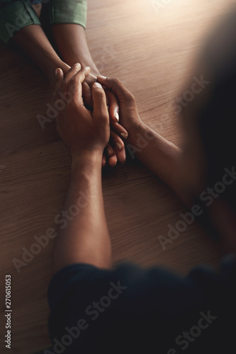 Man consoling girlfriend by holding her hands © StratfordProductions
