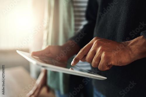 Close-up of a man touching on digital tablet