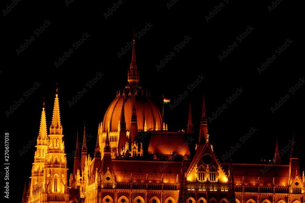 Obraz premium Budapest Hungary, 05.29.2019 Hungarian Parliament Building. night Budapest, glowing in gold. facade and roof of an old building