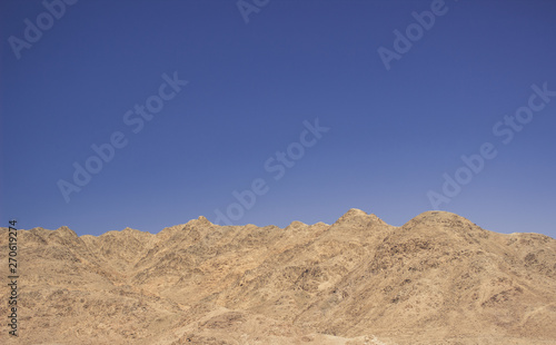 desert rocky mountain ridge background silhouette nature wallpaper pattern scenic landscape on blue sky background with empty space for copy or text