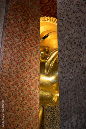 Photography reclining buddha at Wat Pho or another name is Phra Chetuphon Temple, with brigh