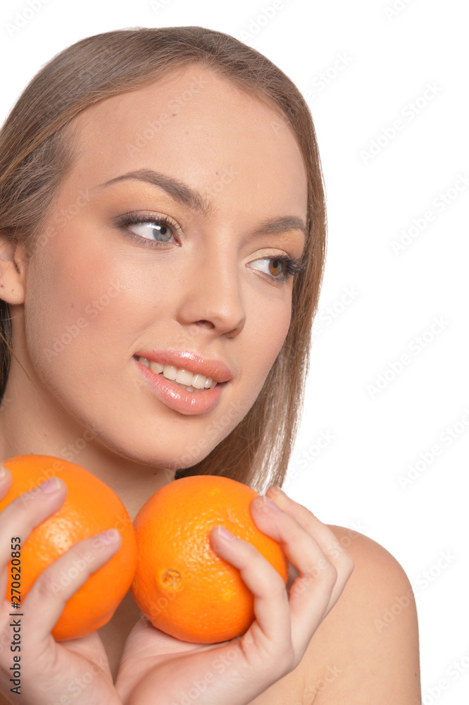 Portrait of young woman posing with oranges on white background Portrait of young woman posing with oranges on white background