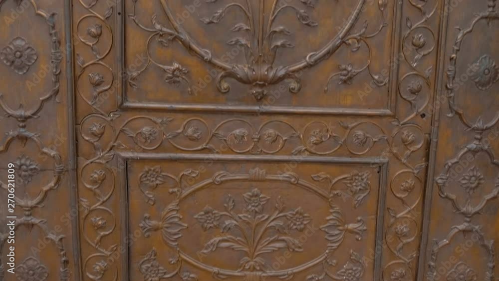 Metal brass door, richly decorated with floral patterns in Indian style Metal brass door, richly decorated with floral patterns in Indian style