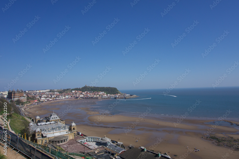 View from clifftops across the bay at Scarborough, Yorkshire, UK on a clear blue sky sunny day