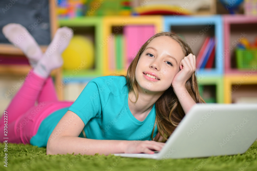Portrait of cute girl with laptop computer on floor Portrait of cute girl with laptop computer on floor