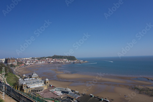 Fototapeta Naklejka Na Ścianę i Meble -  View from clifftops across the bay at Scarborough, Yorkshire, UK on a clear blue sky sunny day