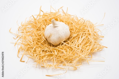 Garlic on the nest with isolated white background shooting in studio.