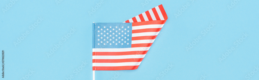 top view of american flag on stick on blue background, panoramic shot top view of american flag on stick on blue background, panoramic shot