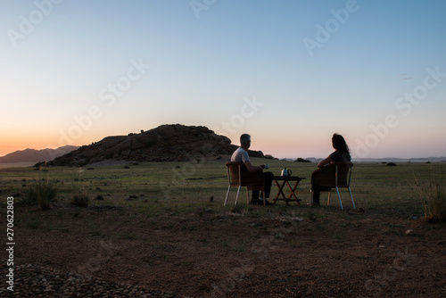 Couple is relaxing at sunset