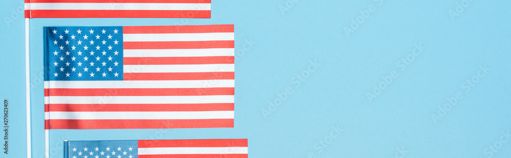panoramic shot of national american flags on blue background panoramic shot of national american flags on blue background