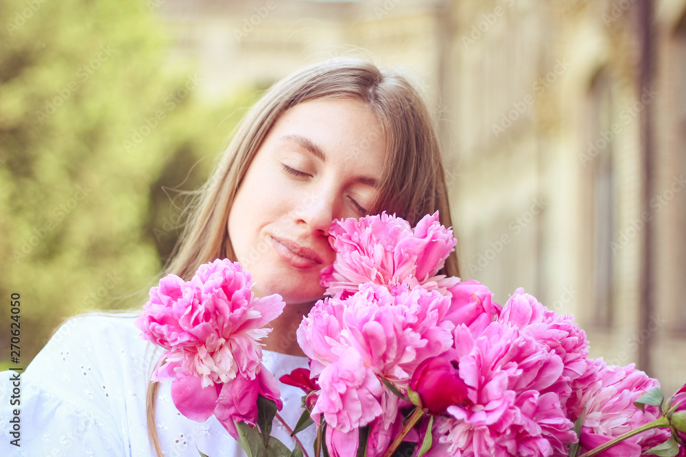beautiful girl, no makeup, natural beauty, feminism. woman in a white dress, crosswise with a bouquet of peonies beautiful girl, no makeup, natural beauty, feminism. woman in a white dress, crosswise with a bouquet of peonies